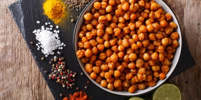 a bowl of roasted chickpeas and the spices used making them