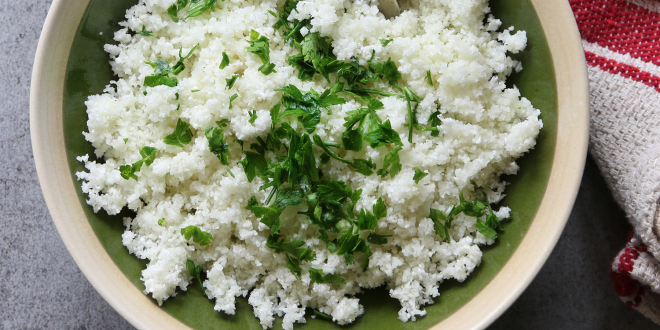 A bowl of grated cauliflower with rosemary.